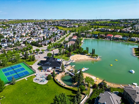 A beachfront community with a pool and a sandy beach.