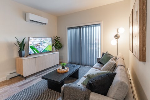 A Living Room With a Flat Screen TV at Cadence at Griesbach, Alberta