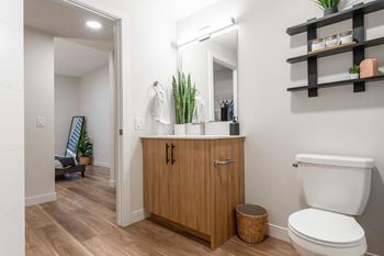 A Bathroom With a Wooden Cabinet at Cadence at Griesbach, Alberta