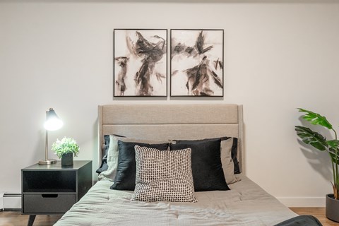 A Bedroom With a Nightstand at Cadence at Griesbach, Alberta