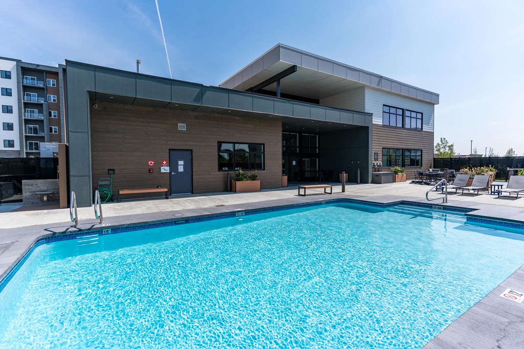 A large swimming pool in front of a modern building.