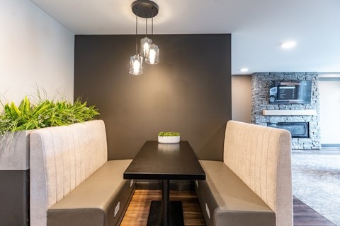 A modern dining area with a table set for two.