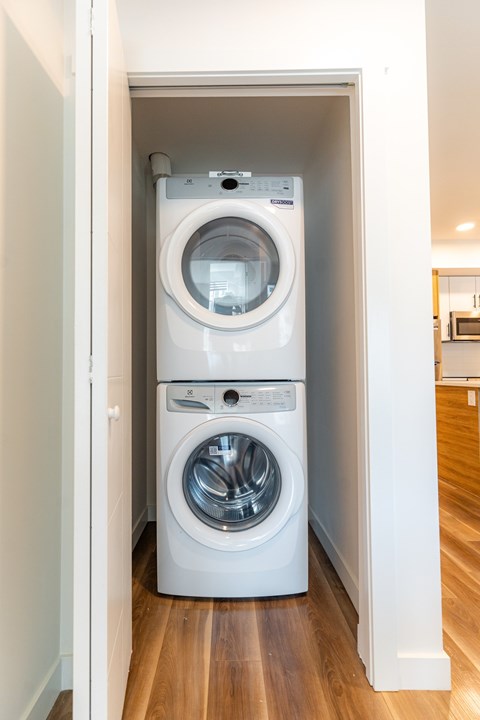 A white washing machine and dryer in a small laundry room.