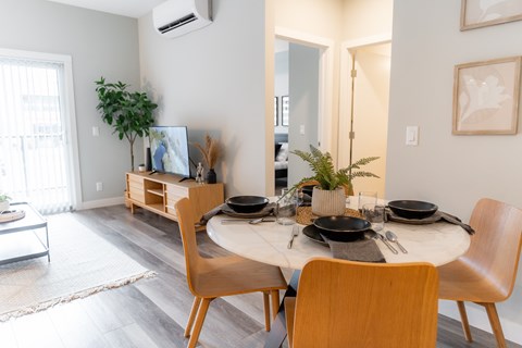 A dining room with a round table set for two.
