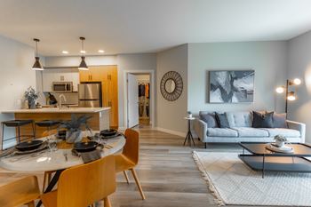 A modern dining room with a wooden table and chairs.