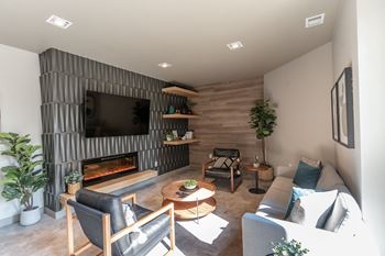 A modern living room with a fireplace and a flat screen TV.