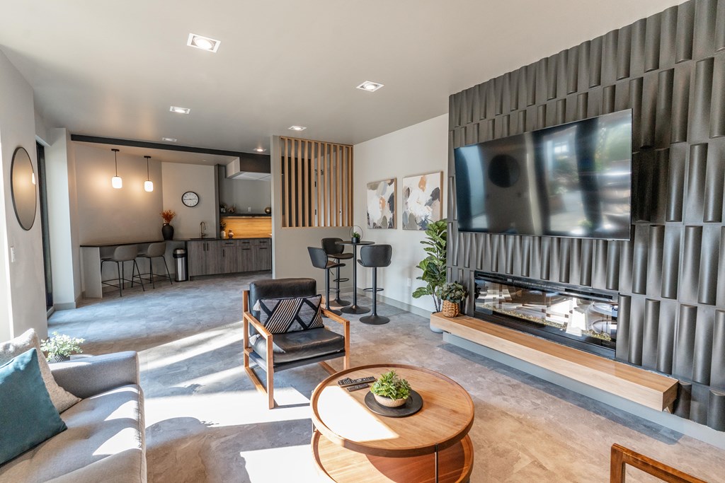 A modern living room with a fireplace and a television.