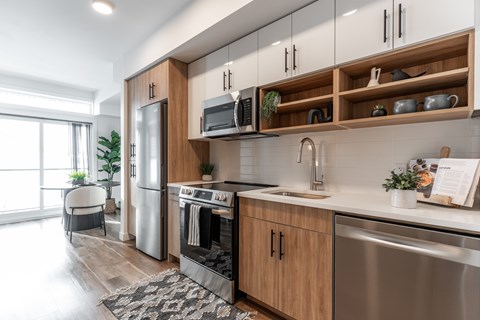 A modern kitchen with wooden cabinets and stainless steel appliances.