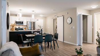 A modern kitchen with a dining table set for four.