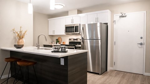 a kitchen with stainless steel appliances and white cabinets
