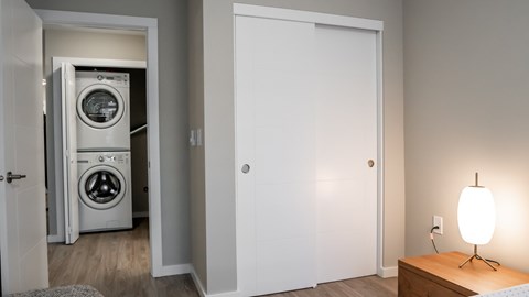 A white door is open to a laundry room.