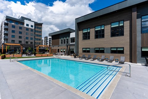 A large swimming pool in front of a building.