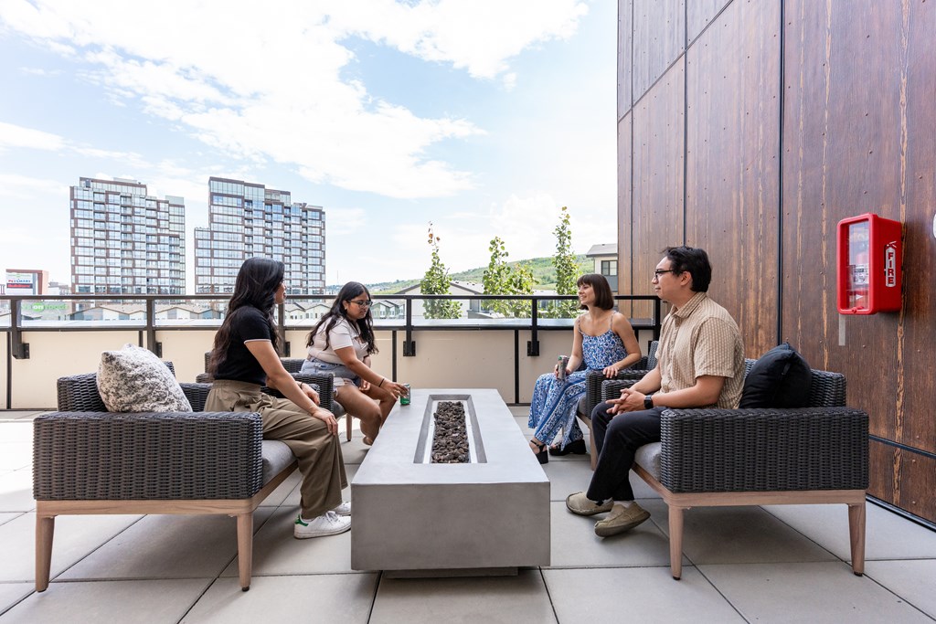 Four people sitting on a patio.