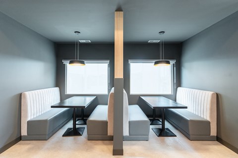 A modern dining area with a long table and benches.