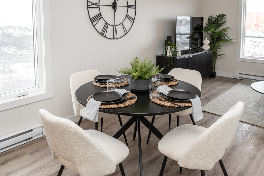 A dining room with a table set for four.