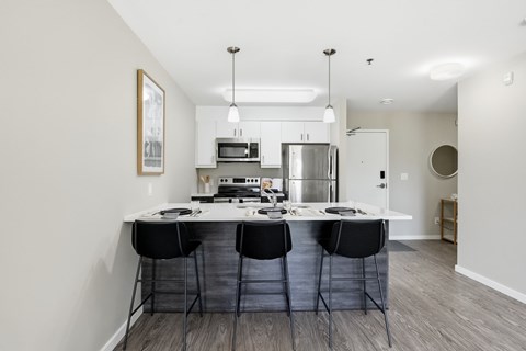 A kitchen with a table and chairs in the middle of the room.