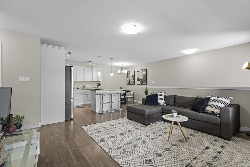 A living room with a grey couch and a coffee table.