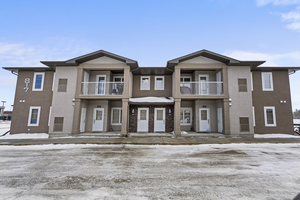 A row of three houses with brown and beige exteriors.