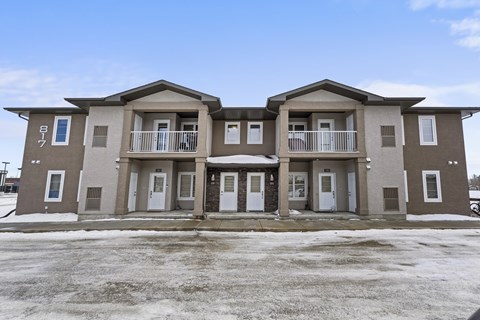 A row of three houses with brown and beige exteriors.
