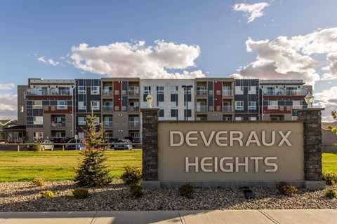 A sign that says Deveraux Heights in front of a building.