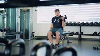 A man is working out in a gym.at Skyway Apartments, Calgary, AB