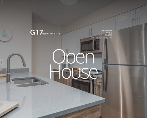 A kitchen with a stainless steel refrigerator and a sink with a faucet.