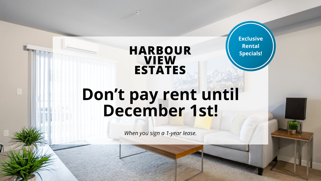 A room with a couch and a table with a sign offering exclusive rental specials.