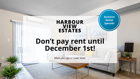 A room with a couch and a table with a sign offering exclusive rental specials.