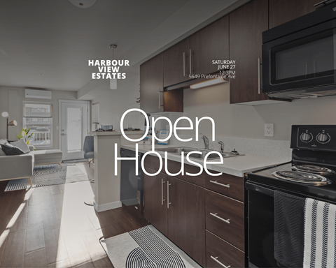 A kitchen with a stove and a microwave with a sign that says Open House.