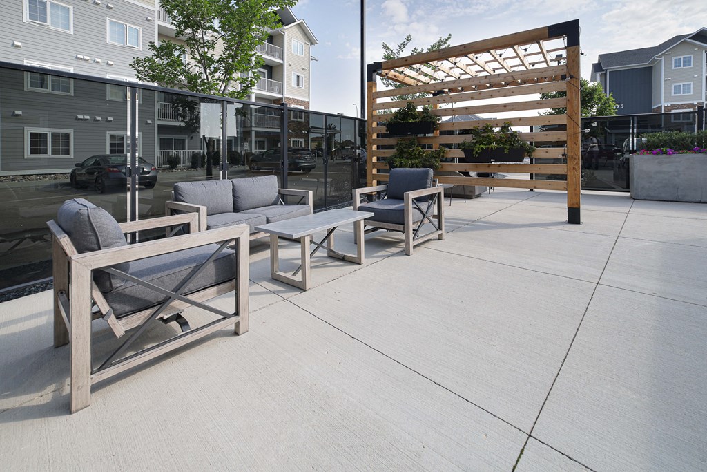 a patio with chairs and a pergola