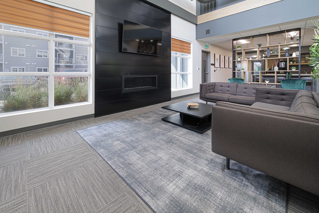 a living room with couches and a television in a building