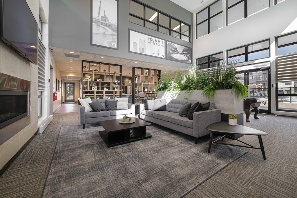 A living room with a grey couch and a coffee table.