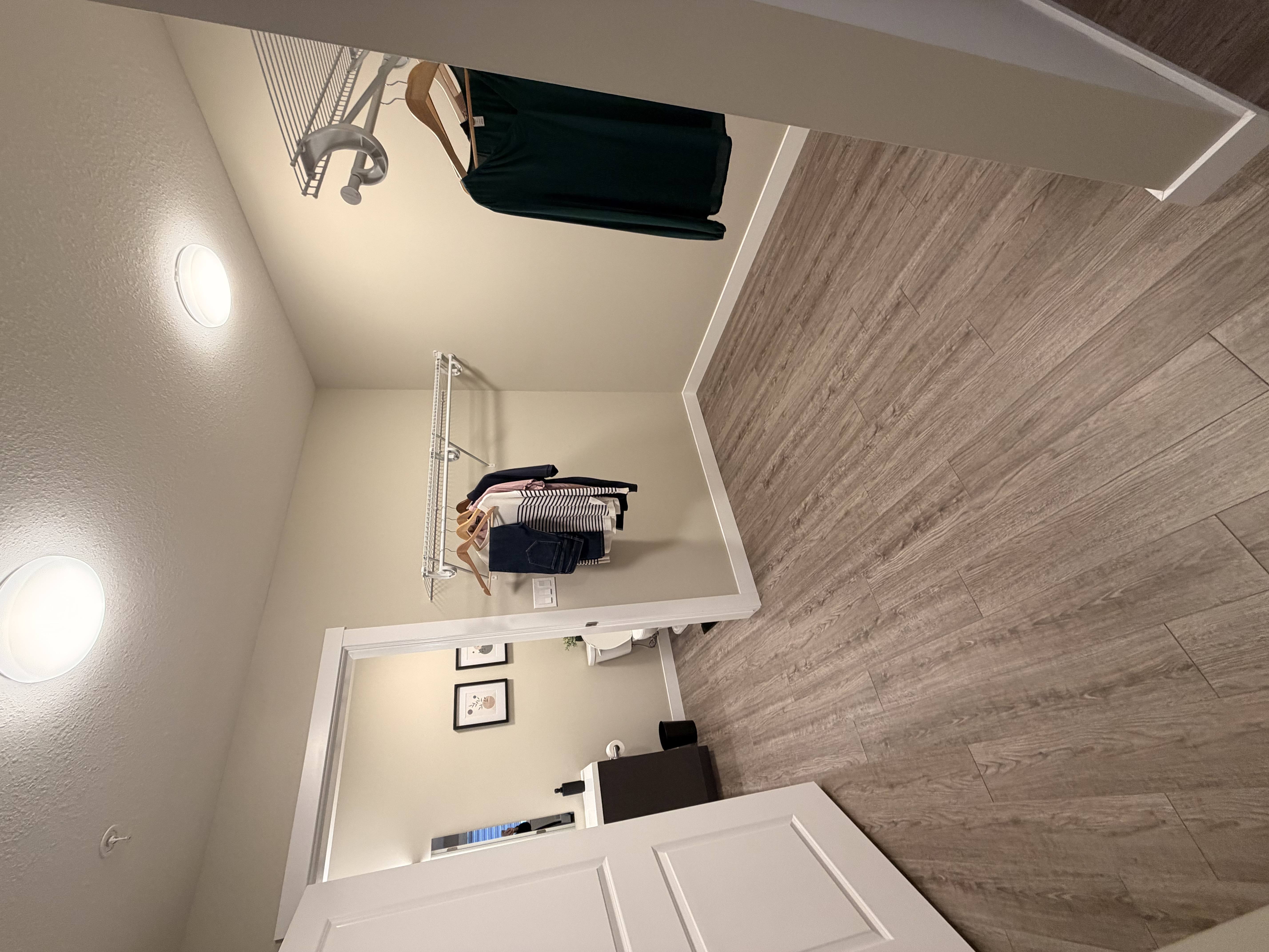 A staircase with a wooden floor and a white wall.