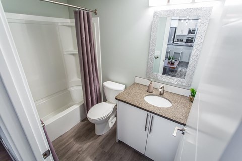 A bathroom with a toilet, sink, and shower.