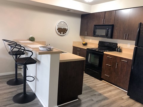 a kitchen with a island and a stove and a microwave