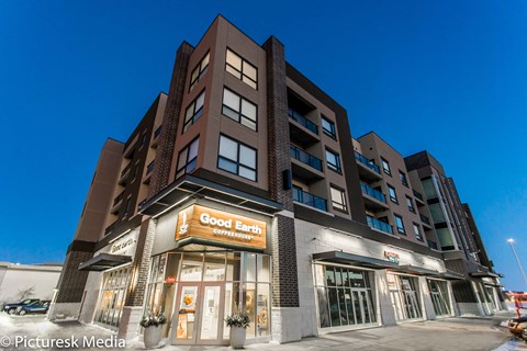 A building with a sign that says "Good Earth Coffee" on it.