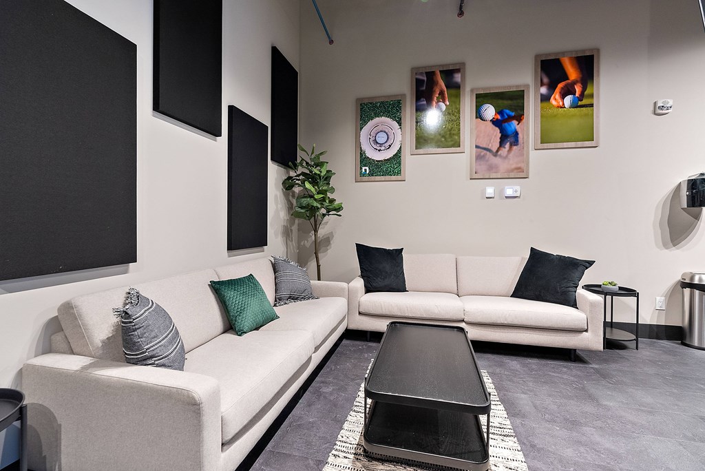 A living room with a white couch, a black coffee table, and a grey rug.at Raymond Block, Alberta