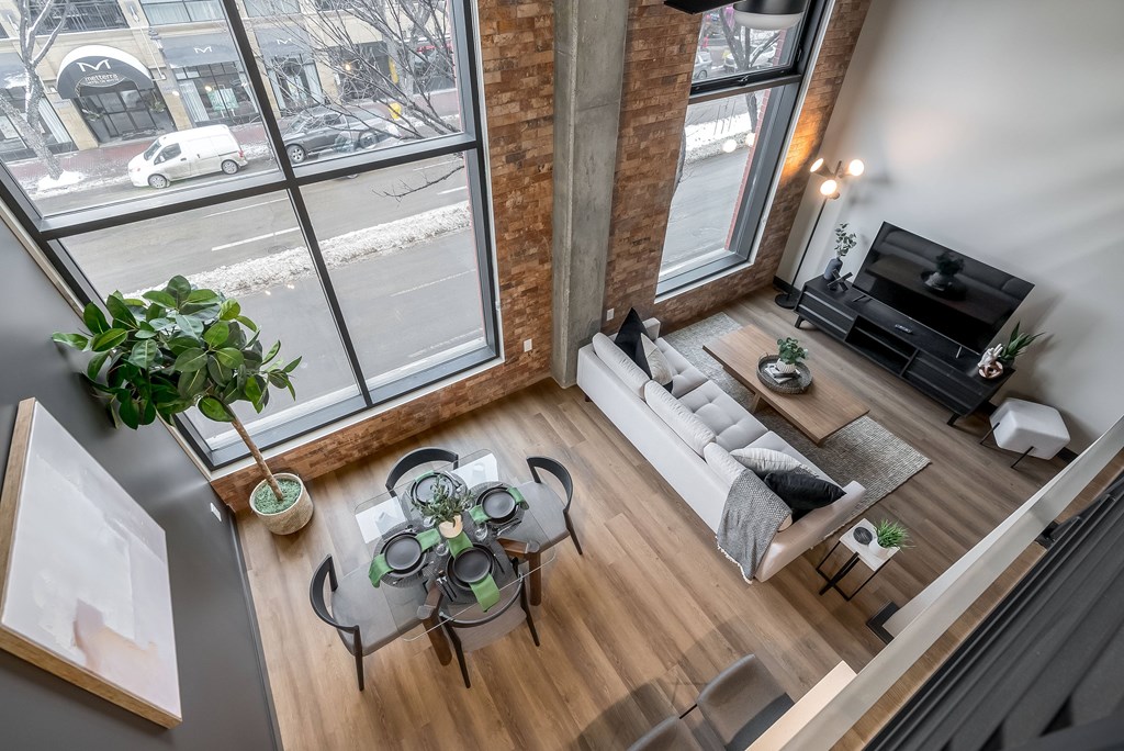 A living room with a glass table and a white couch.at Raymond Block, Edmonton, AB T6E 3R7