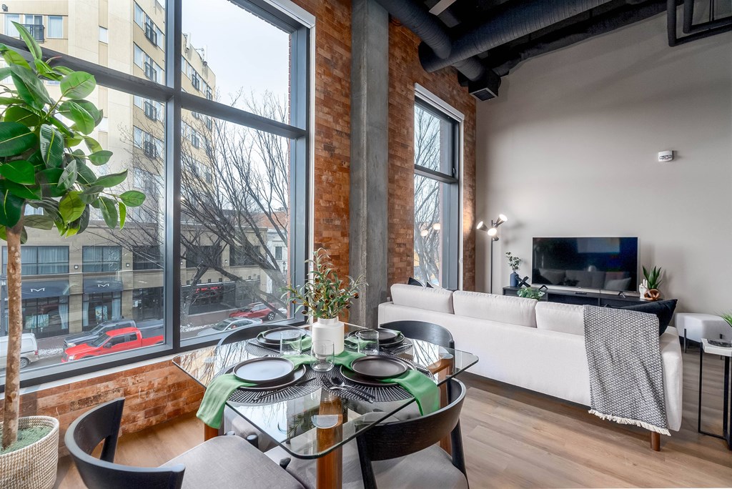A modern living room with a glass table and a white couch.at Raymond Block, Alberta