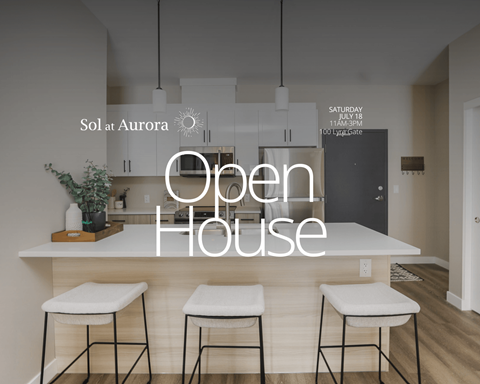 A modern kitchen with a bar stool and a sign that says Open House.