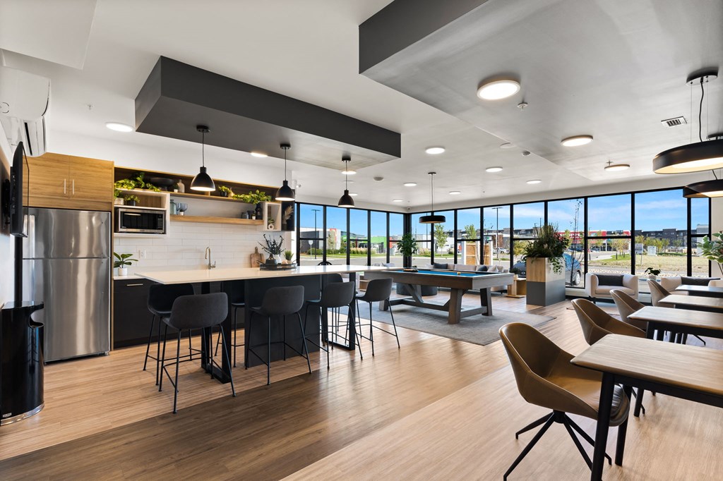 an open kitchen and dining area with tables and chairs