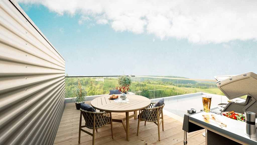 a terrace with a table and chairs and a view of the ocean