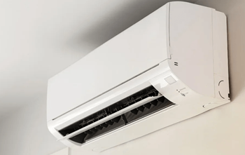 A white air conditioner unit mounted on a wall.
