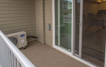 A room with a window and a wall-mounted air conditioner.
