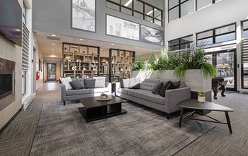 A modern living room with a grey couch and a coffee table.