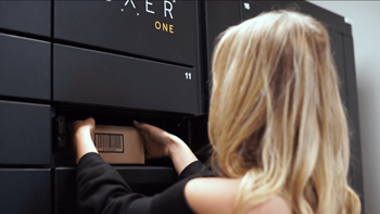a woman pulling a box out of a black drawer at Vibe Apartments at Arbour Lake in Calgary, AB, T3G 4J2