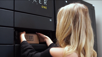 a woman pulling an item out of a microwave oven