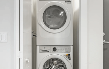 A front-loading washing machine with the door open.