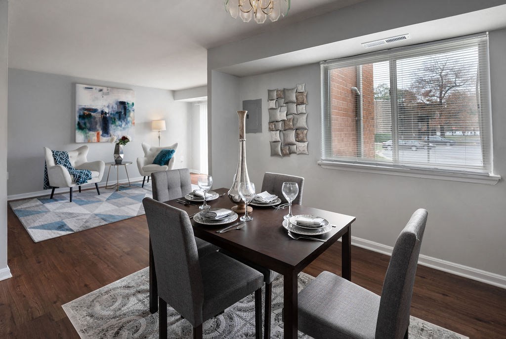 a dining room with a table and chairs at The Glendale Residence, Lanham, MD