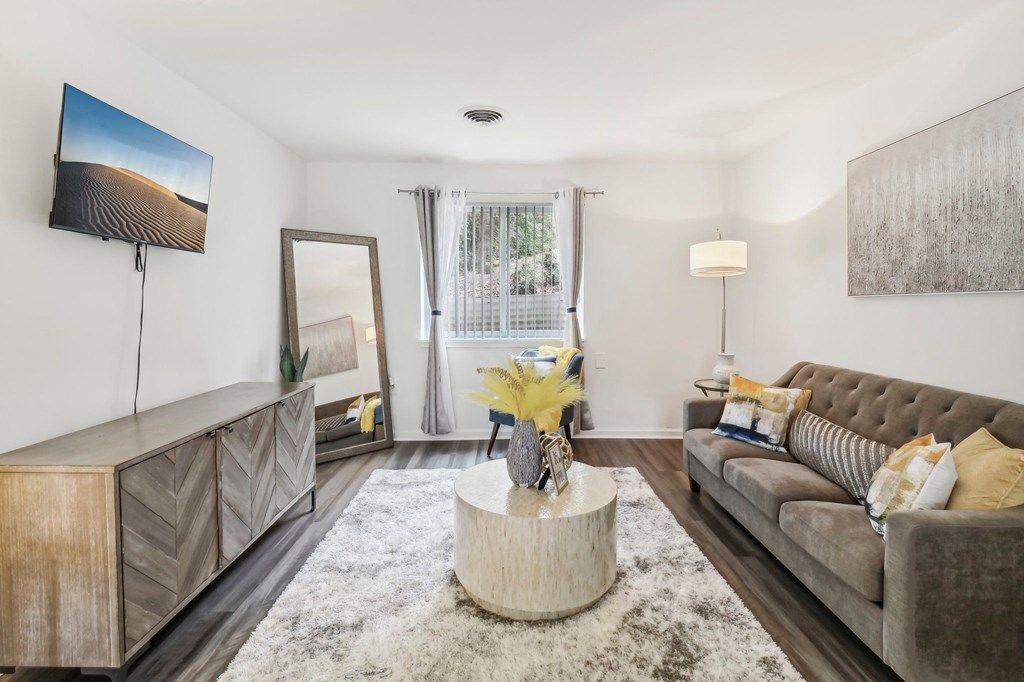 a living room with a couch and a coffee table at Oaks at Oxon Hill, Oxon Hill, Maryland